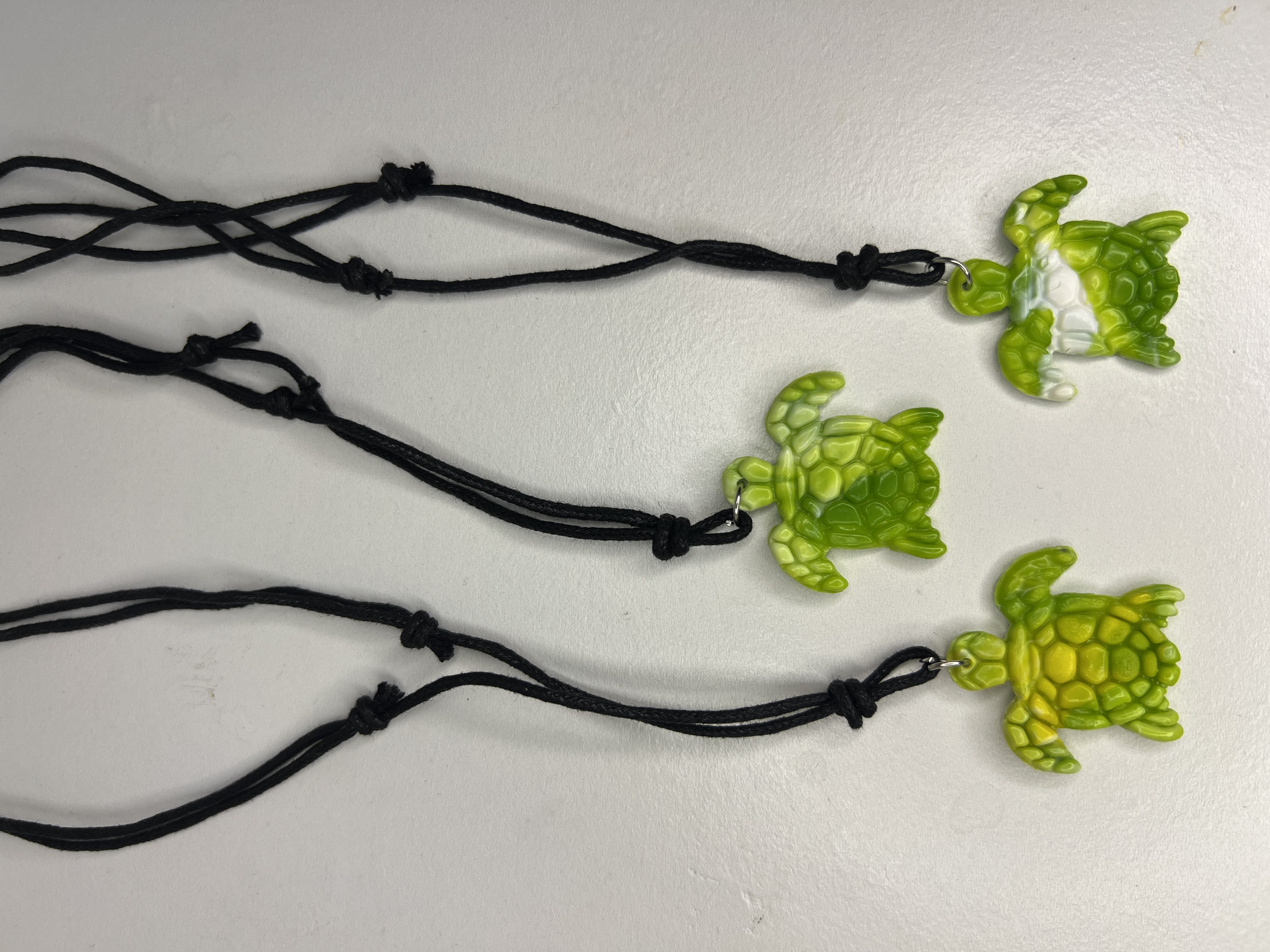 Three green turtle pendants