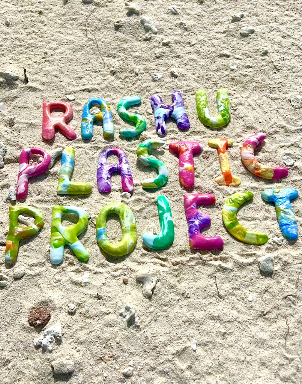 Rashu Plastic Project spelled out in recycled letters on a beach